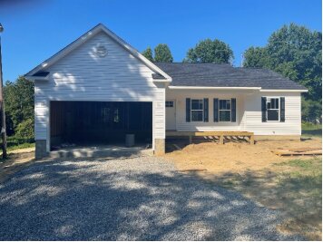 Completed new home with garage and gravel drive