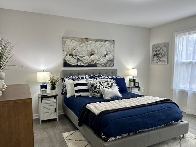 Guest bedroom staged in navy and white